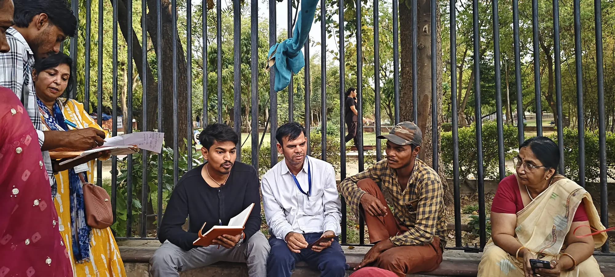 Foundation volunteers listening to and recording a community member's concerns during outreach in Jaipur.