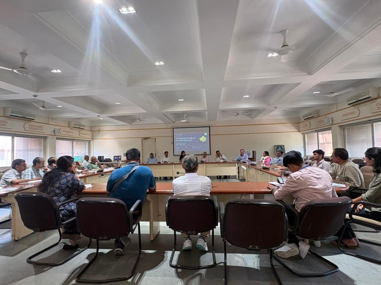 Attendees seated around a conference table during the Rajasthan youth opportunity discussion in Jaipur.