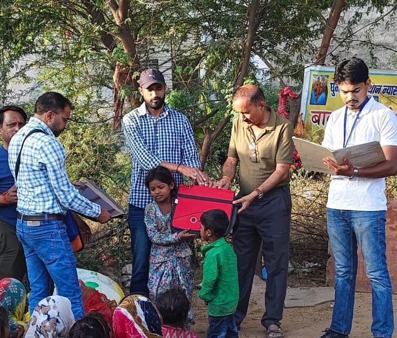 Foundation volunteers coordinating education material distribution with community members.